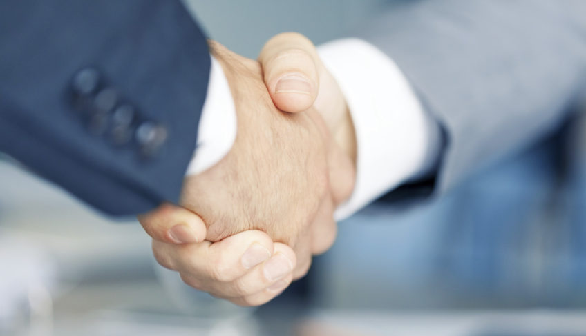Two businessman shaking hands, copy space